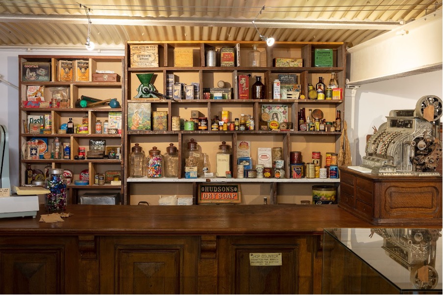 A counter with shelves full of vintage items