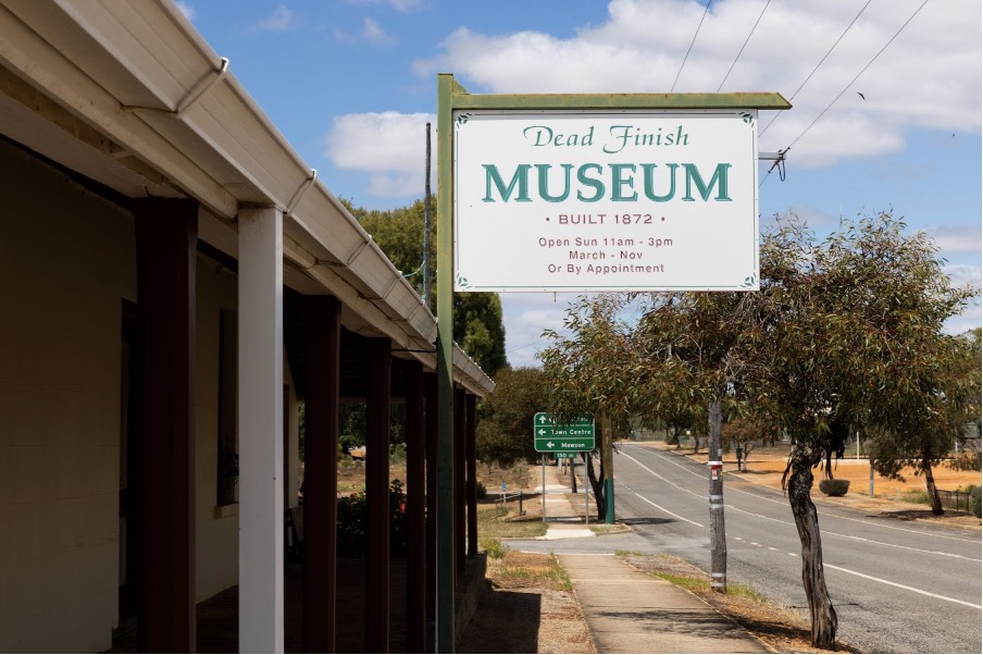 Exterior of a building with a hanging museum sign