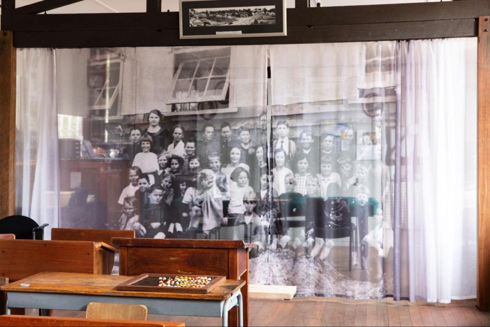 A photo of children behind a curtain
