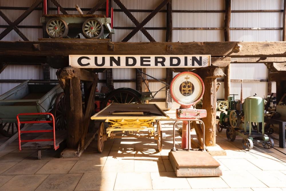 A collection of vintage machinery and other items including a Cunderdin sign