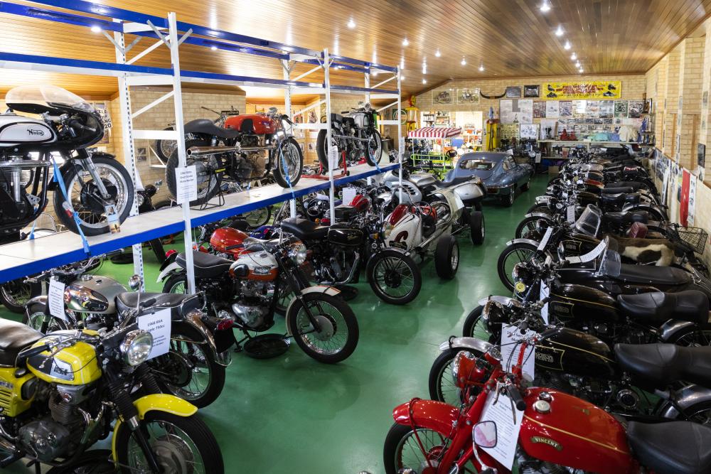 A room full of motorbikes on display.