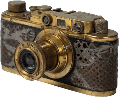 A gold plated camera with crocodile skin